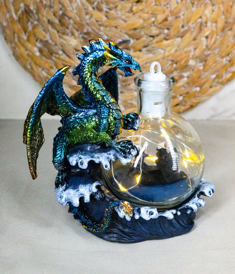 Metallic Sea Dragon Rising Above Waves by LED Glass Bottle With Ship Figurine