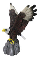 Majestic Soaring Bald Eagle Figurine with Outstretched Wings on Rocky Cliff