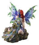 Large Fantasy Fairy With Blue Iridescent Train Wings Sitting By Peacock Statue