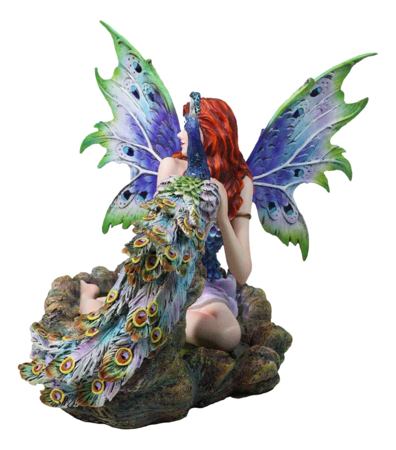 Large Fantasy Fairy With Blue Iridescent Train Wings Sitting By Peacock Statue