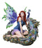 Large Fantasy Fairy With Blue Iridescent Train Wings Sitting By Peacock Statue