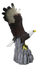 Majestic Soaring Bald Eagle Figurine with Outstretched Wings on Rocky Cliff