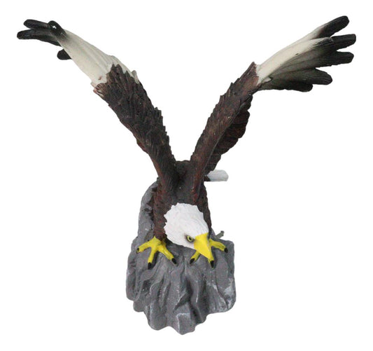 Majestic Soaring Bald Eagle Figurine with Outstretched Wings on Rocky Cliff