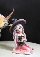 Gothic Beautiful Witch In Pink Dress And Magical Hat Holding Black Cat Figurine