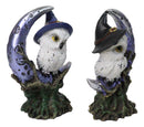 Pair of Snow Owls With Witch Hats Perching On Cratered Crescent Moon Figurines