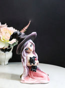 Gothic Beautiful Witch In Pink Dress And Magical Hat Holding Black Cat Figurine