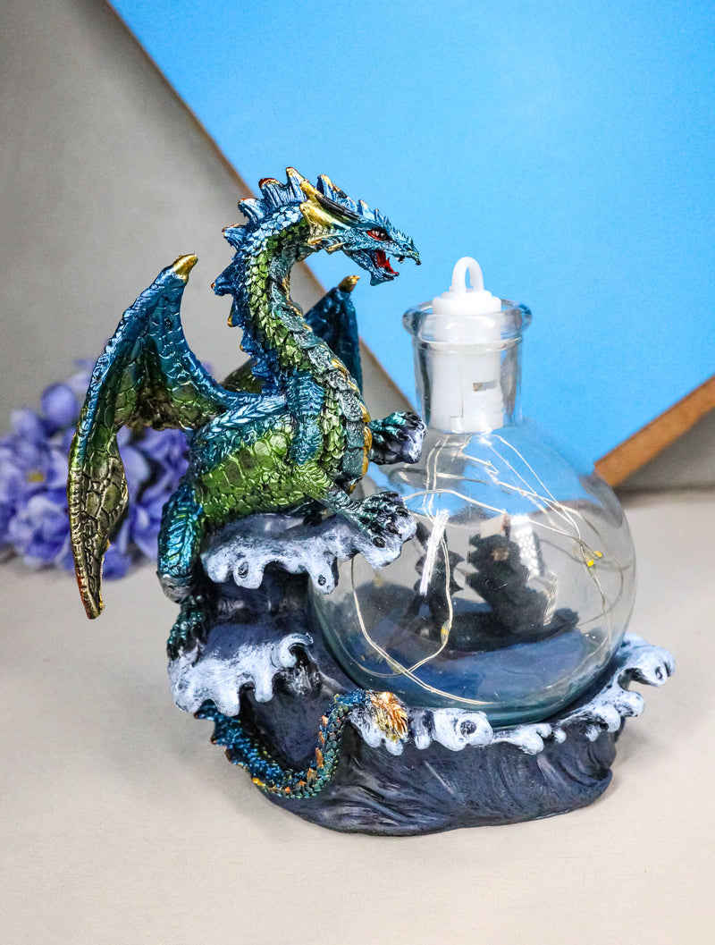 Metallic Frozen Sea Dragon Rising Above Waves by Glass Bottle With Ship Figurine