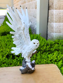 Large White Snowy Owl Figurine with Outstretched Wings on Snow-Covered Branch