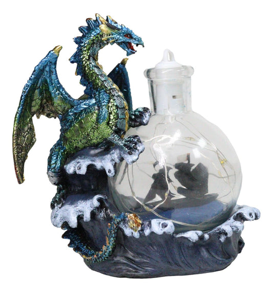 Metallic Frozen Sea Dragon Rising Above Waves by Glass Bottle With Ship Figurine