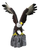 Majestic Soaring Bald Eagle Figurine with Outstretched Wings on Rocky Cliff