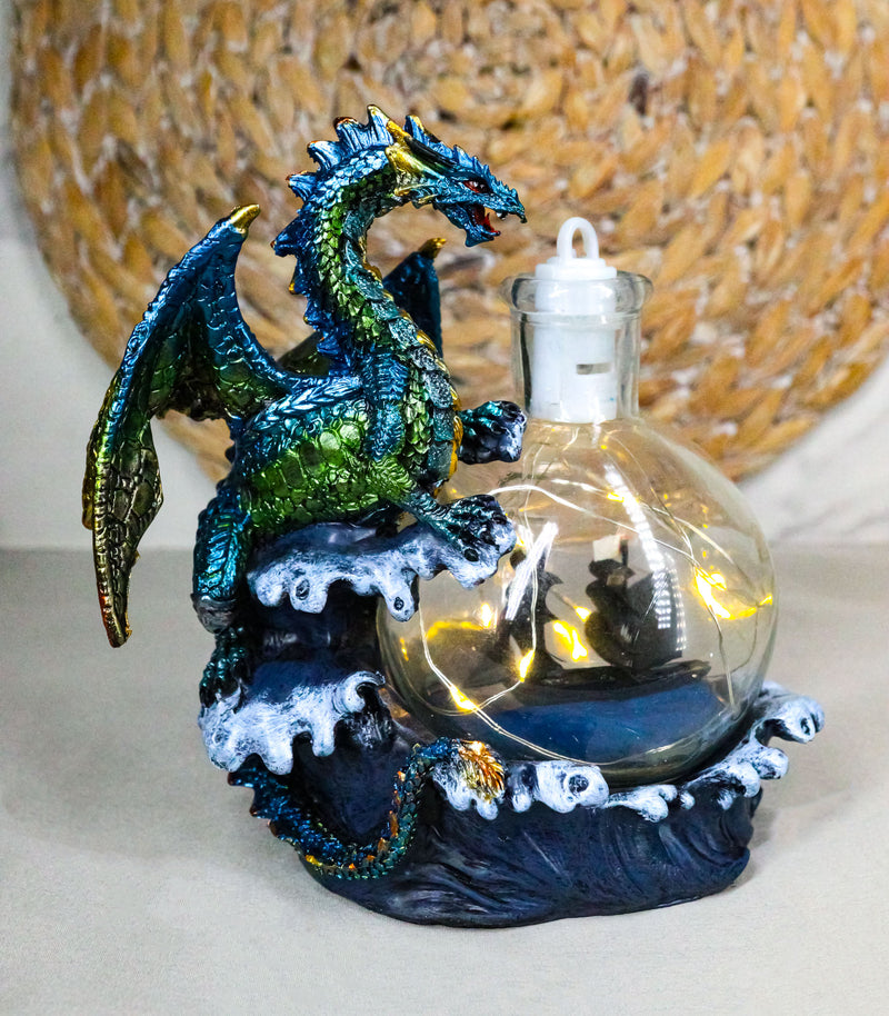 Metallic Sea Dragon Rising Above Waves by LED Glass Bottle With Ship Figurine