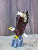 Majestic Soaring Bald Eagle Figurine with Outstretched Wings on Rocky Cliff