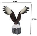 Majestic Soaring Bald Eagle Figurine with Outstretched Wings on Rocky Cliff