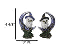 Pair of Snow Owls With Witch Hats Perching On Cratered Crescent Moon Figurines
