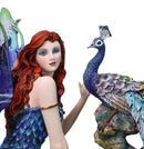 Large Fantasy Fairy With Blue Iridescent Train Wings Sitting By Peacock Statue