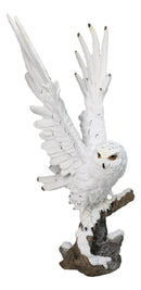 Large White Snowy Owl Figurine with Outstretched Wings on Snow-Covered Branch