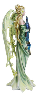 Beautiful Green Fairy With Colorful Flowers Carrying A Blue Peacock Figurine