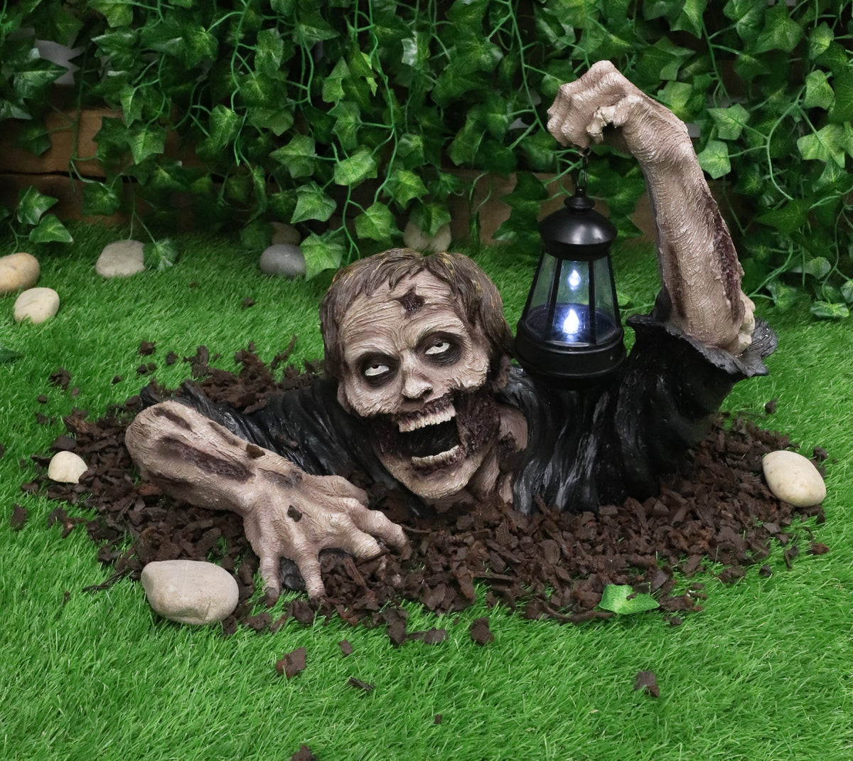 Zombie garden figurine with a lantern for Halloween decor