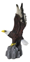 Majestic Soaring Bald Eagle Figurine with Outstretched Wings on Rocky Cliff