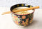 Colorful Floral Summer Blossoms On Black Ramen Soup Bowl With Chopsticks Set