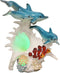 Ebros Nautical Ocean Family 3 Dolphins Swimming Over Giant Sea Conch Clownfishes and Anemones Statue with Colorful LED Light 9.5" Tall