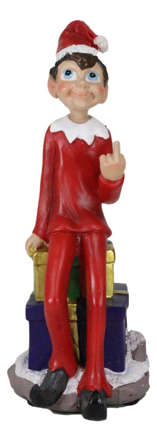 Naughty Christmas Elf Flipping The Bird Sitting On Santa Presents